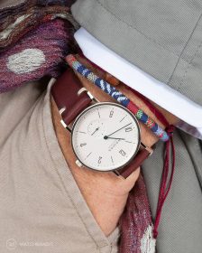 NOMOS Glashütte Tangente on burgundy vintage leather strap pocket shot